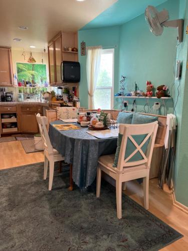 a kitchen with a table and chairs in a room at NovaGarden in San Diego