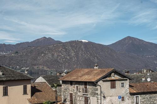 a mountain in the distance with houses and mountains at L&B HOUSE in Orta San Giulio
