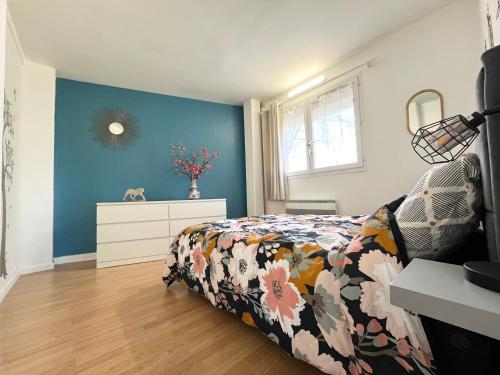 een slaapkamer met een bed en een dressoir bij Colors of life in Torcy