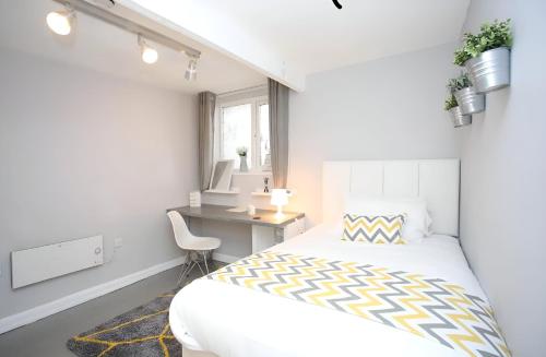 a white bedroom with a bed and a desk at New Modern Room With En Suite Park Street Room 2 in Luton