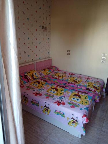 a bedroom with a bed with hello kitty bedding at شقه جناح فندقي متكامل in Aswan
