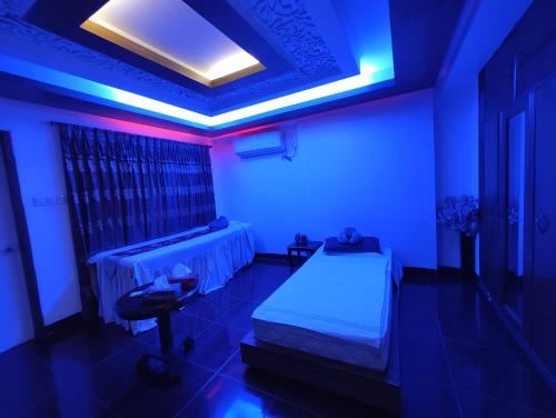 una camera con letto e luce blu di Spas Personal Care a Dhaka