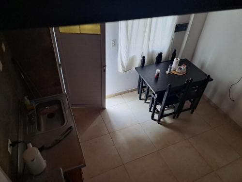 a dining room with a table and a table and chairs at Temporarios Corrientes in Corrientes