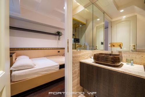a bedroom with a bed and a bathroom with a sink at Da I Gemelli Loft by PortofinoVip in Portofino
