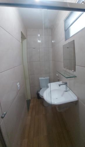 a bathroom with a white sink and a toilet at Solo Nunes in Manaus