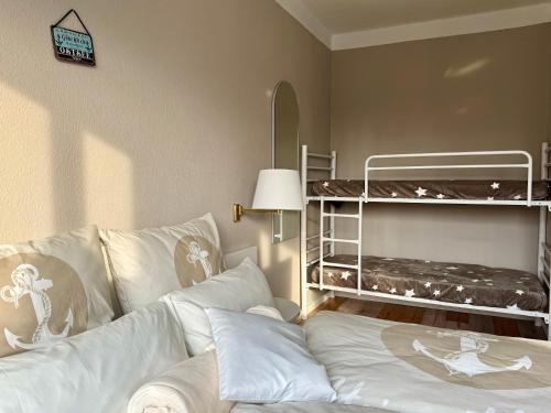 a bedroom with a bed and a bunk bed at Pension Ostsee-Strand in Börgerende-Rethwisch