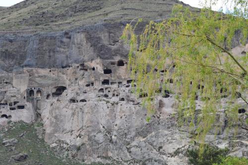 a cliff witholithicolithicolithicolithicolithicolithicolithicolithicolithicolithicolithicolithicolithic at Tirebi Farmhouse in Vardzia