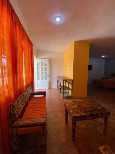 a living room with a couch and a table at Portal Malila in Tancama