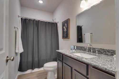a bathroom with a sink and a toilet and a shower at NEW Const Sleeps 6 Pool - close to Pkwy in Pigeon Forge