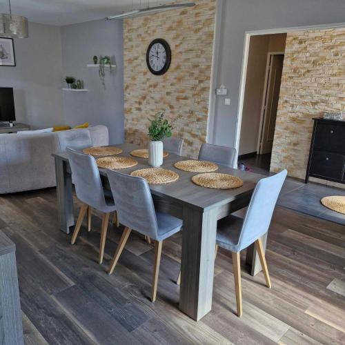 a dining table and chairs in a living room at Maison de vacances in Appenwihr