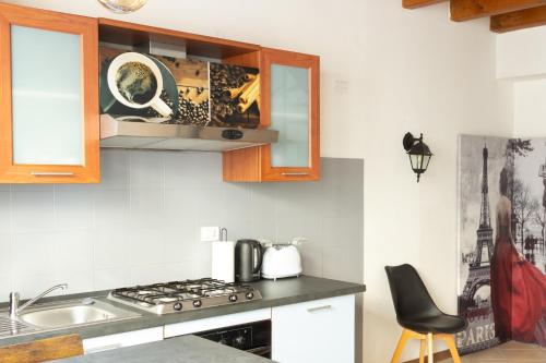 a kitchen with a sink and a stove top oven at Verona Nest in Verona