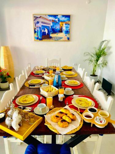 a dining room table with food on it at Riad Ghazal in Essaouira