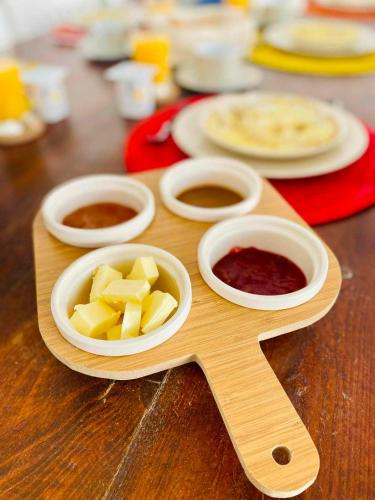 a wooden cutting board with food on a table at Riad Ghazal in Essaouira