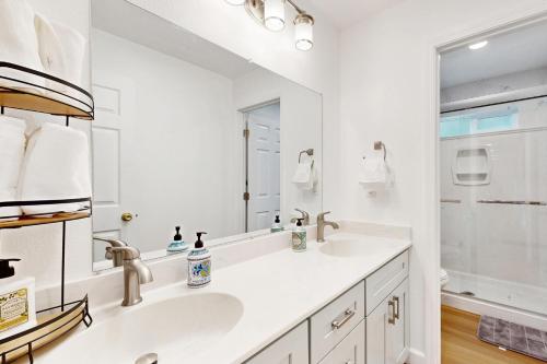 a white bathroom with a sink and a mirror at Sunrise Haven in Santa Clara in Santa Clara