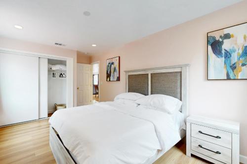 a white bedroom with a white bed and a window at Sunrise Haven in Santa Clara in Santa Clara