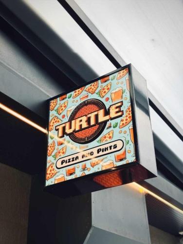 a sign hanging from the ceiling of a building at La Quinta by Wyndham Ellerslie Auckland in Auckland