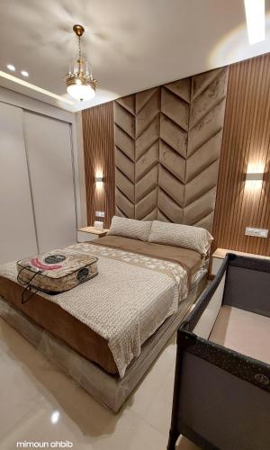 a bedroom with a large bed in a room at اقامة الاحلام in Nador