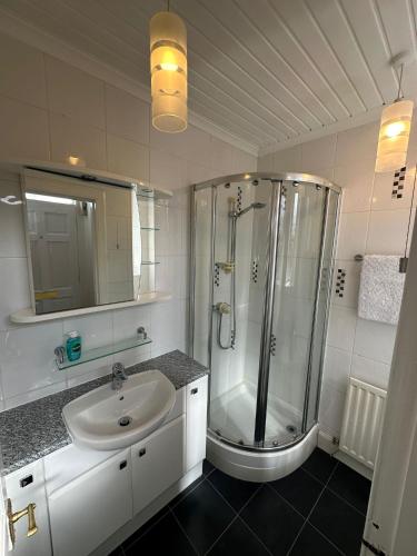 a bathroom with a shower and a sink at Scott Street Modern Flat in Galashiels