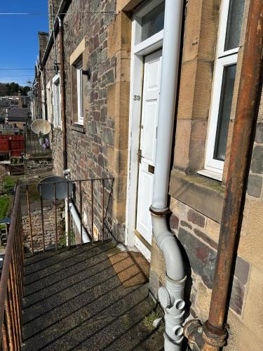 a pipe on the side of a building at Scott Street Modern Flat in Galashiels