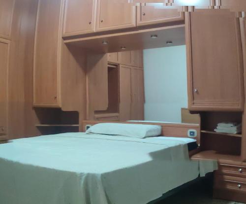 a bed in a room with wooden cabinets at Dorado 3 in Badalona