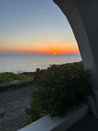 a sunset over the ocean from a patio at Punta Tre Pietre 37 - Vista Tramonto in Scauri
