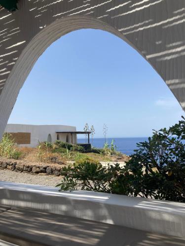 a view of the ocean through an archway at Punta Tre Pietre 37 - Vista Tramonto in Scauri
