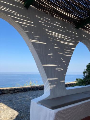 a view of the ocean from under a bridge at Punta Tre Pietre 37 - Vista Tramonto in Scauri