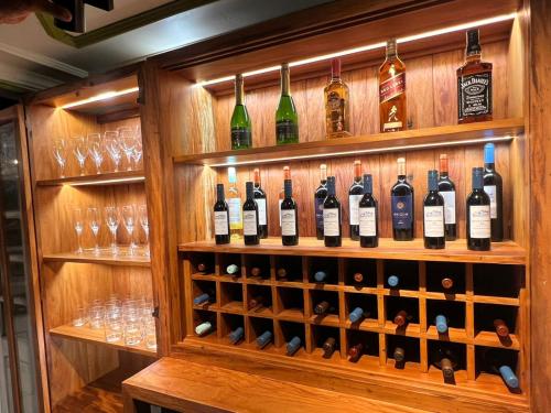 a display of wine bottles and glasses in a wine cellar at Hotel Pousada Casa Grande in Ouro Preto