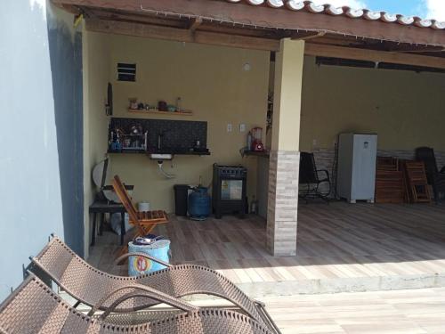 a patio with a fireplace and a table and chairs at Pousada Vista Verde in Paracuru