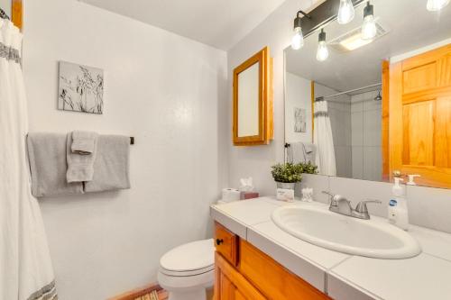 a white bathroom with a sink and a toilet at Jackson Condo with Fireplace Less Than Half Mi to Snow King! in Jackson