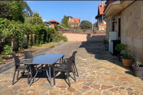 a table and chairs sitting on a patio at Somo&Pet Apartamento a 300 metros de la playa. in Somo