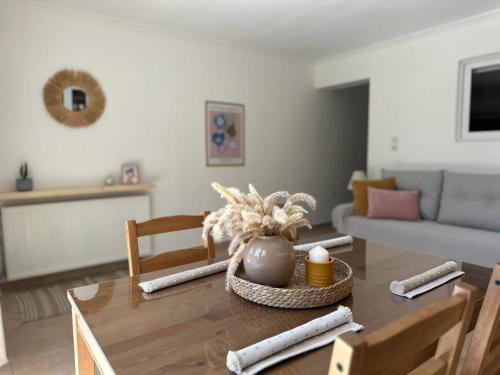 a living room with a table and a couch at Corfu Lakeside Cottage in Kanoni