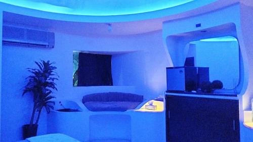 a living room with a room with a blue light at Spa Chaac in Puerto Vallarta