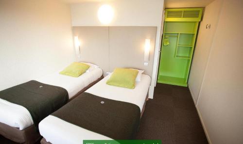 two beds in a room with green and white at Downtown in Cairo