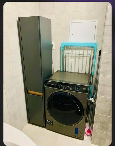 a microwave in a kitchen with a refrigerator at Euphoria/luxurious accomodation in Košice