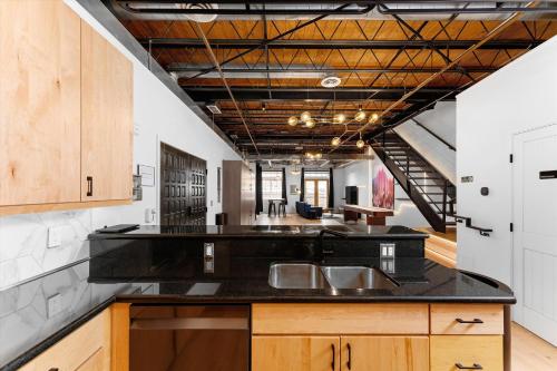 a kitchen with a black counter top and wooden cabinets at Hotel Residential of Denver in Denver