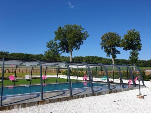 a swimming pool with a metal frame around it at La grange des rosiers in Cambron