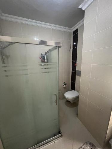 a bathroom with a shower and a toilet at CN Villa Didim in Didim
