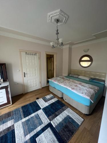 a bedroom with a bed and a rug at CN Villa Didim in Didim