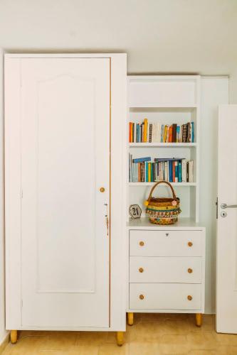 a white closet with a book shelf at Casa Silvana, Capri - Relaxando en el verde in Capri