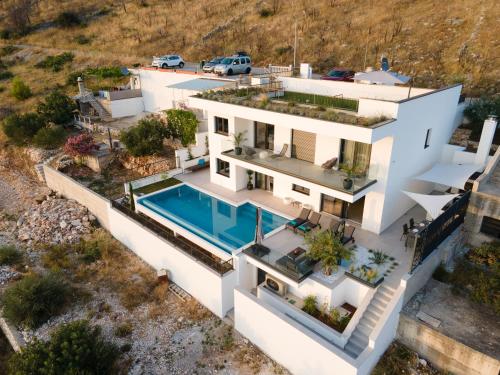 an aerial view of a house with a swimming pool at Villa Laganini in Rogoznica