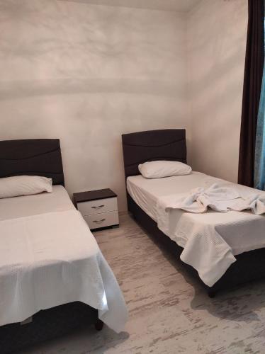 two beds sitting next to each other in a room at Zübeyde Hanım Homes in İzmir