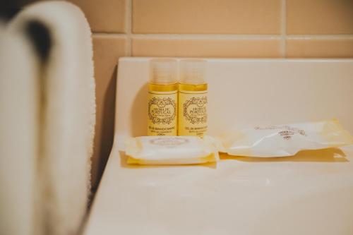 two bottles of mustard sitting on top of a counter at Casa de Campo da Quinta da Pegada in Óbidos