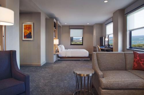 a hotel room with a bed and a couch and a table at Hilton Chicago in Chicago