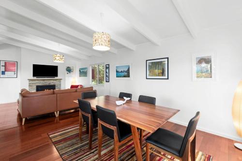a dining room with a table and chairs and a couch at The Arthouse at Mossy in Mossy Point