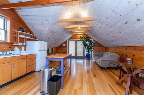 a kitchen and living room in a log cabin at Bright and Cozy Treehouse Apartment in Burlington