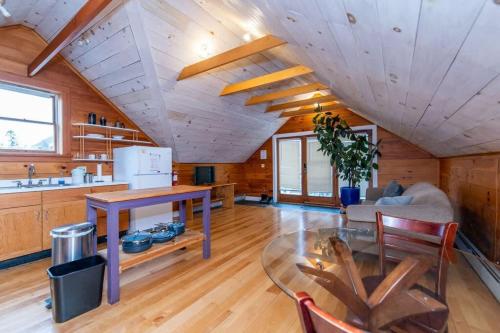 a kitchen and living room with a wooden ceiling at Bright and Cozy Treehouse Apartment in Burlington