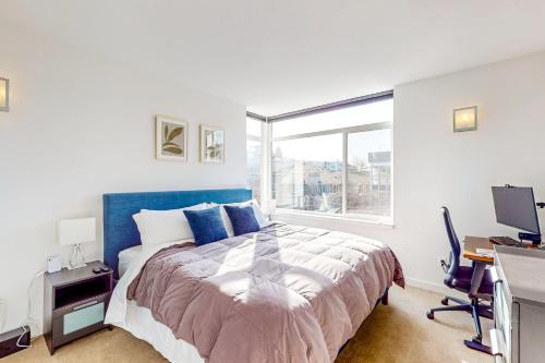 a bedroom with a bed and a desk and a window at Urban Oasis in Seattle