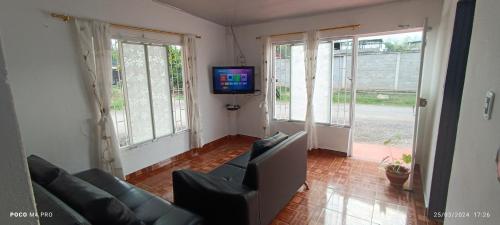 a living room with a couch and a tv at CASA DANY in Guaduas
