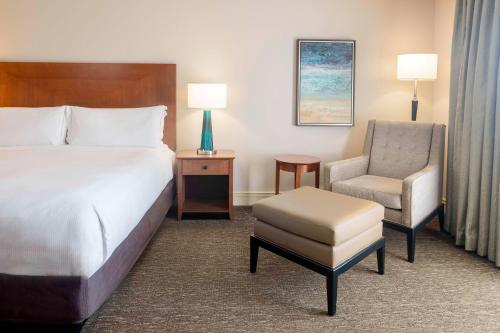 a hotel room with a bed and a chair at Hilton St. Petersburg Carillon Park in St Petersburg